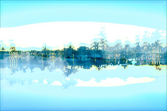 abstract shoreline emerges out of darkness with blue skies and water in the foreground