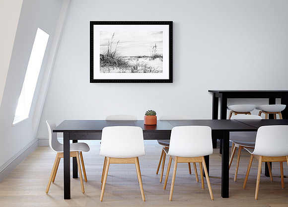 A dining room with table and chairs with 'Dunes B&W' image on the wall