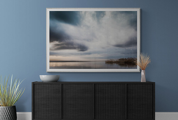 A dining room wall showing my image 'Cloud Explosion' hanging above the sideboard