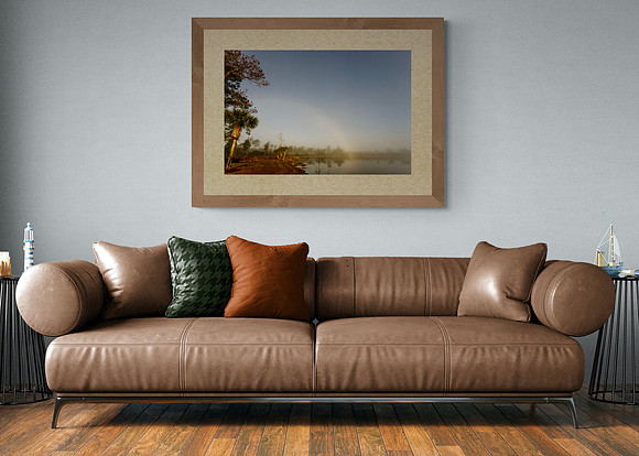 a living room with my image 'Rainbow in the Mist' hanging above a sofa.