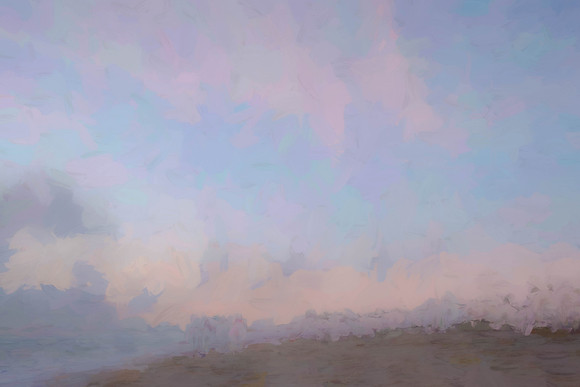 Painterly look to scene of sand, surf and sunrise colors in sky