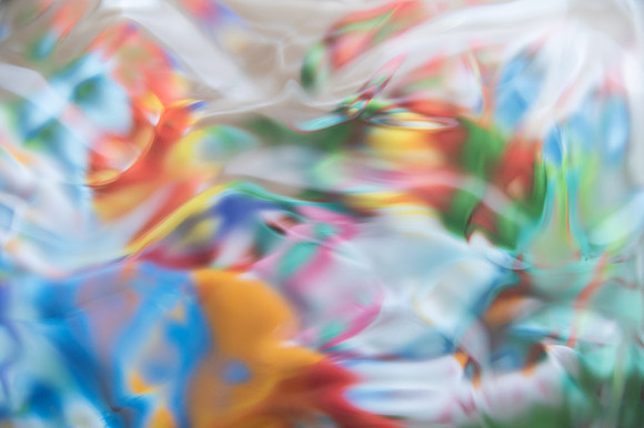 A piece of multi-colored silk swirling under water