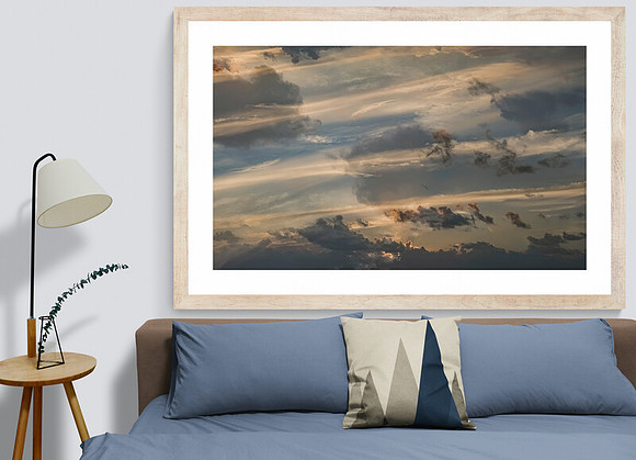 Image of many clouds and orange sunrise rimmed horizon