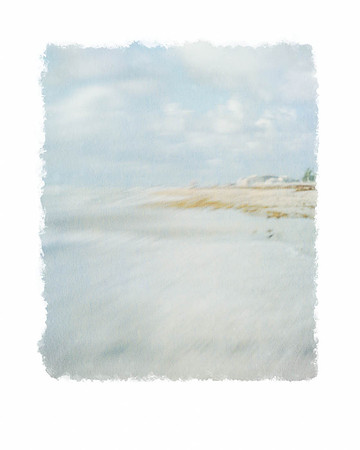 Painterly vire from water's edge of shoreline homes in the distance